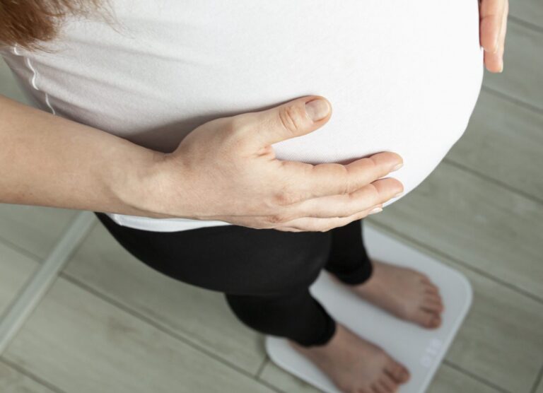 pregnant-woman-is-weighed-bathroom-scale-scaled-1